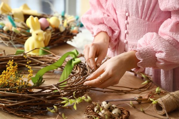 Woman,Making,Beautiful,Easter,Wreath,On,Wooden,Table,,Closeup